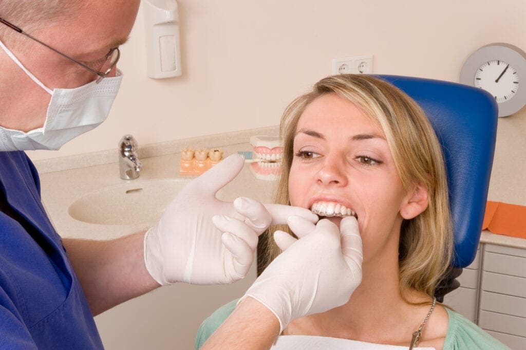 A woman receiving Invisalign treatment services in Seattle, WA